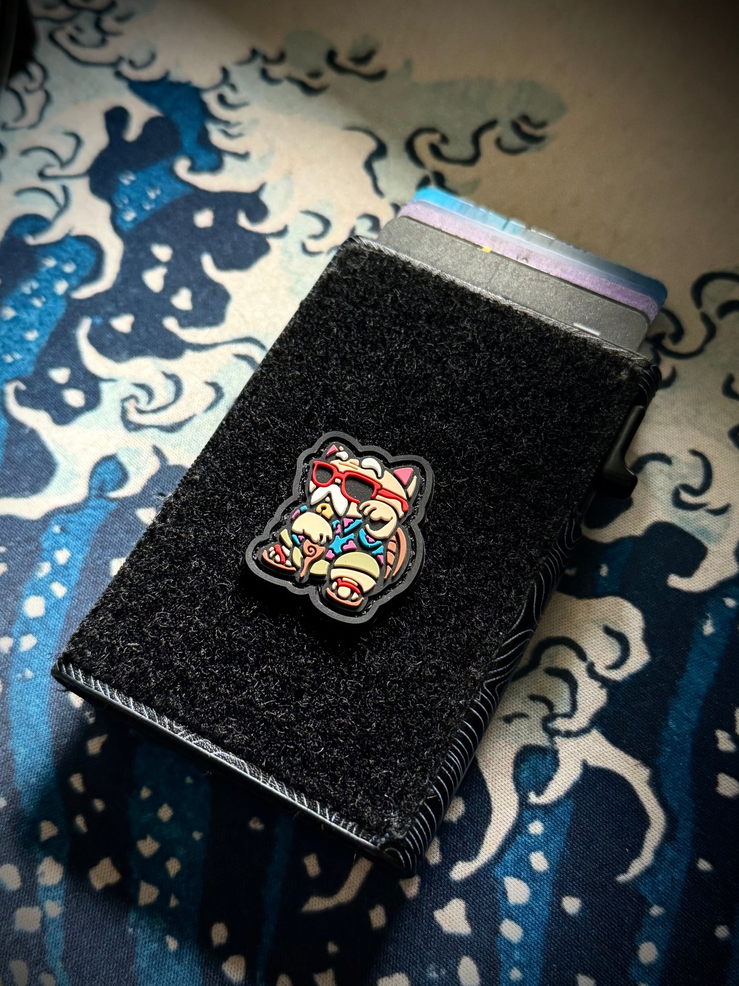 Master Hermit Neko RE ranger eye pvc morale patch of a Colorful cat patch showing an old man with a cane and sunglasses on a velcro wallet with a great wave background.