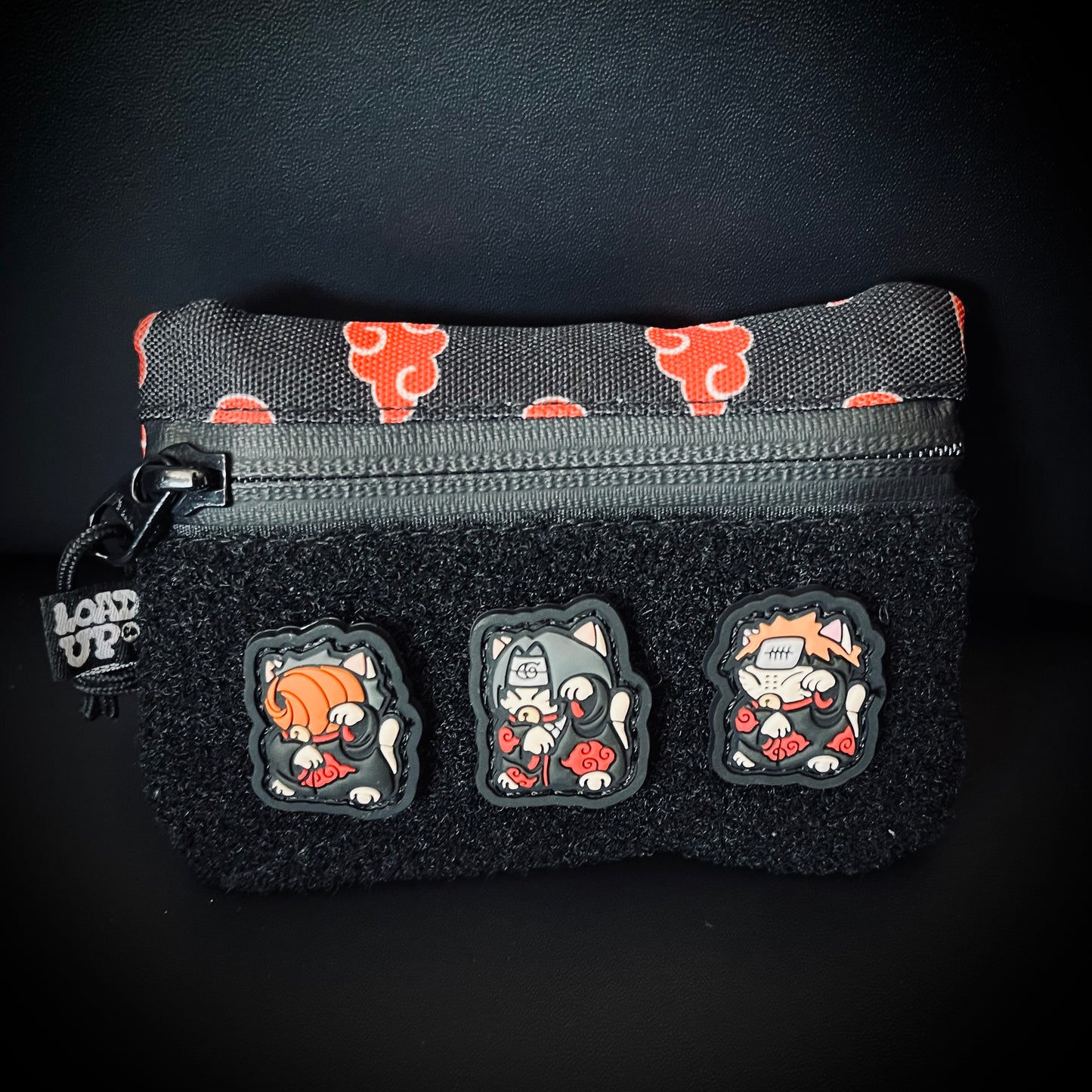 Sidekick 002 Pouch - Akatsuki pocket organizer featuring a anime-inspired red cloud pattern with LOADUP.co Tobi, Itachi, and Pain Neko patches on a black background.