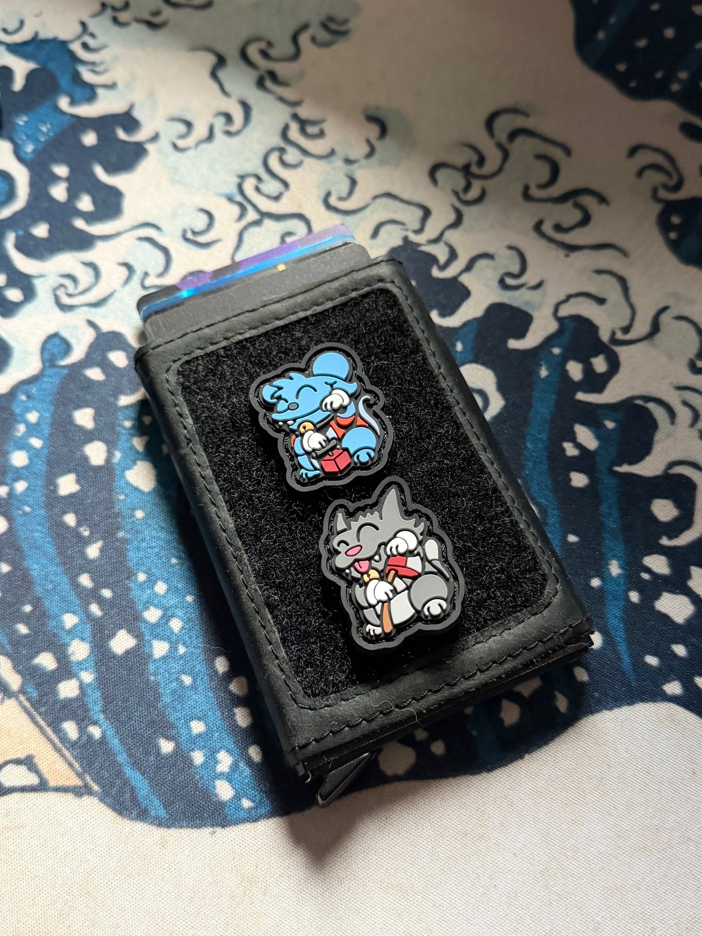 Cat Mouse Neko RE set ranger eye patches on a Ghost 001 Velcro wallet with a Great Wave background.
