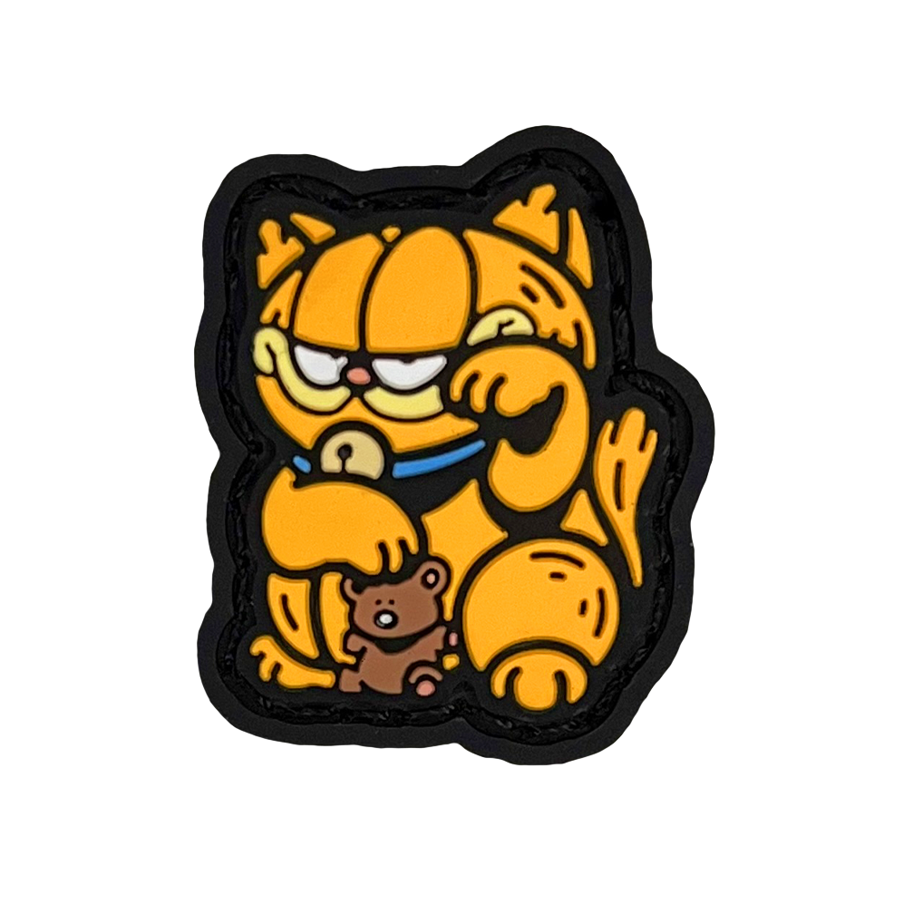 Garfield striking a 'lucky cat' (neko) pose for good fortune. He is holding a teddy bear.
