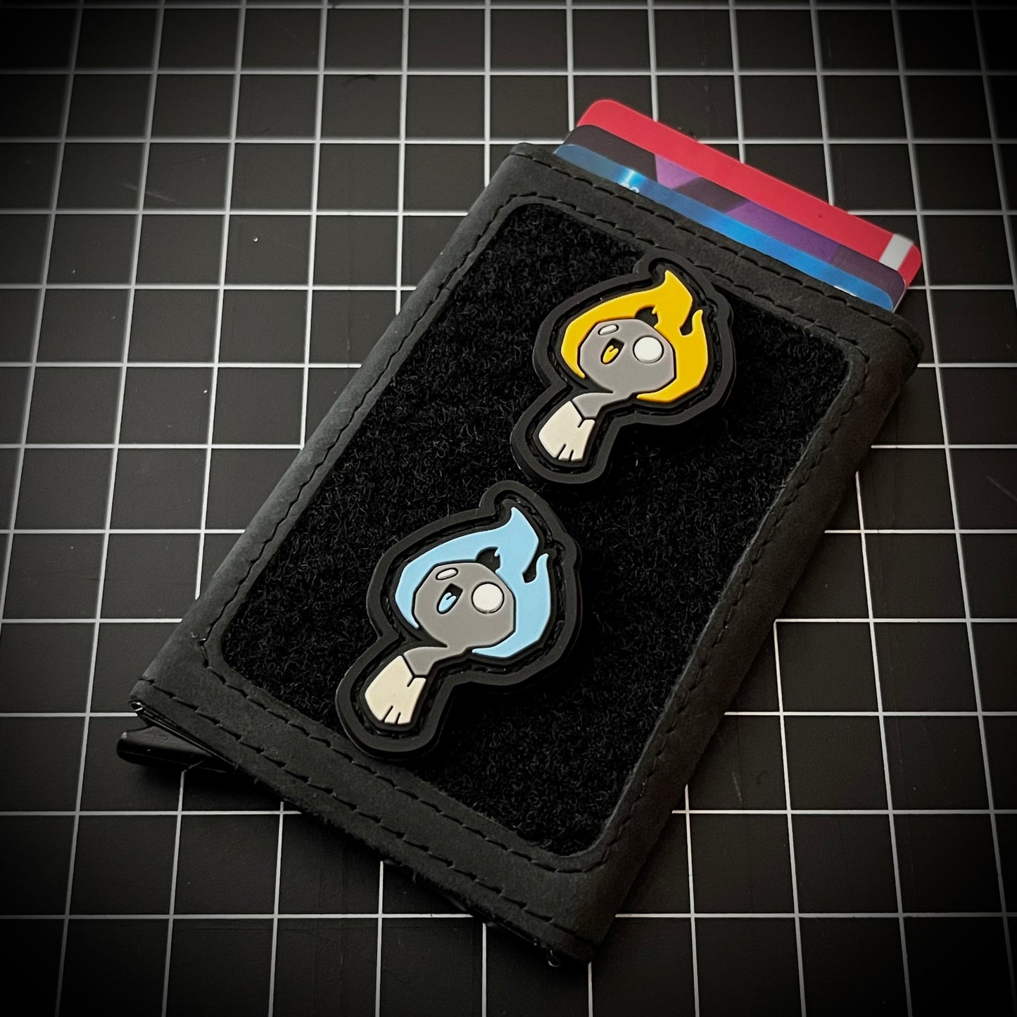 Matchy RE - Blue and Orange PVC ranger eye morale patch of a smiling cartoon character resembling a lit match with a blue flame.
