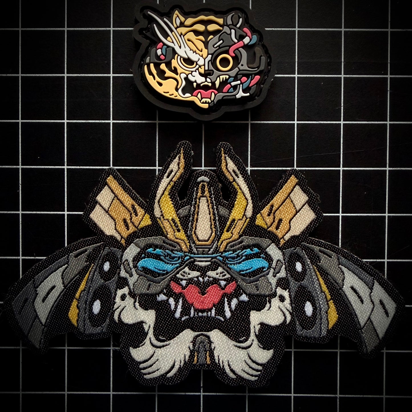 Tigers N Torches Patch Set of the TNT patches against a black grid background