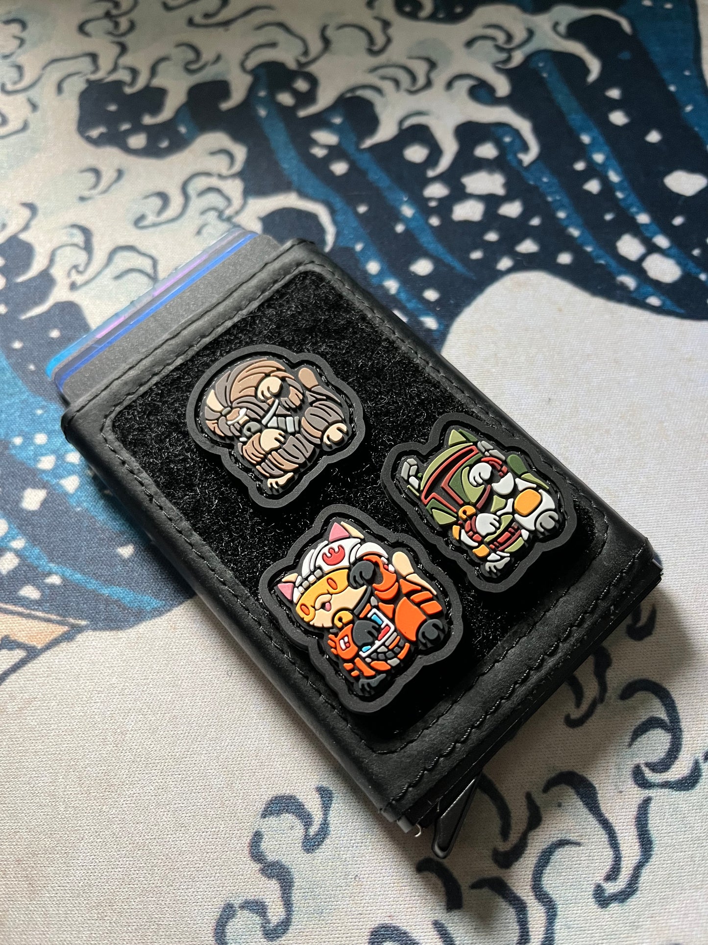 2D PVC ranger eye morale patch of a cartoon characters standing in a lucky cat maneko pose featuring X-Wing Pilot Neko RE, Chewbacca Neko RE, and Boba Fett Neko RE.