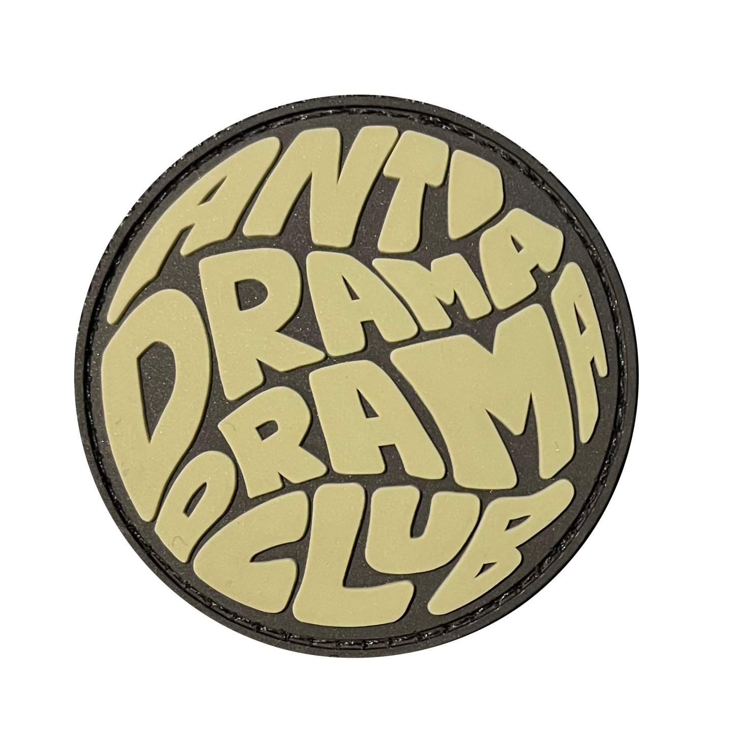 Anti Drama Drama Club RE PVC ranger eye morale patch - A circle round patch that says Anti Drama Drama Club. Primary color is green beige.
