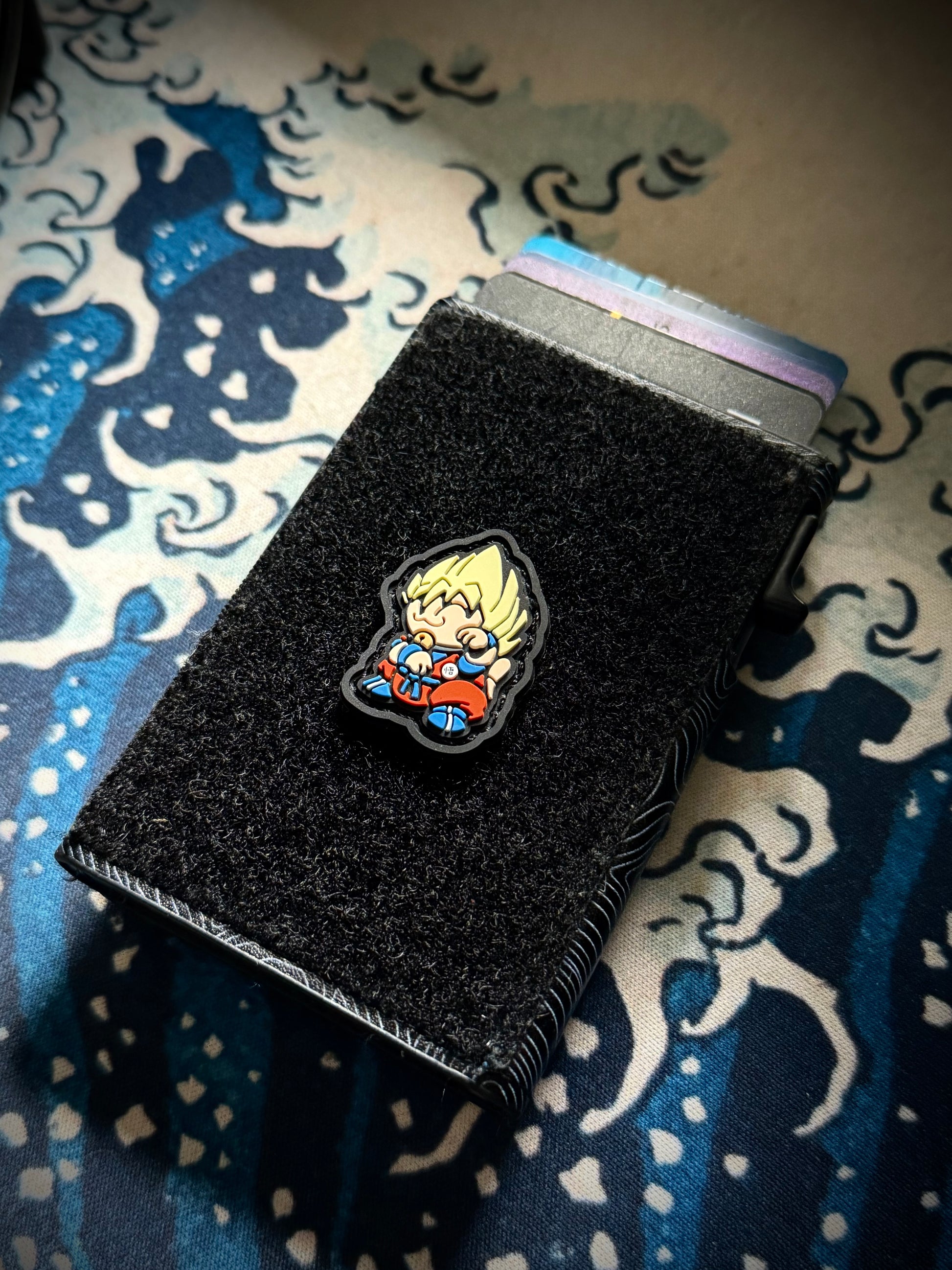 DBZ2 Neko RE Dragon Ball PVC ranger eye morale patch - Colorful character patch with spiky hair on a velcro wallet with a great wave background.