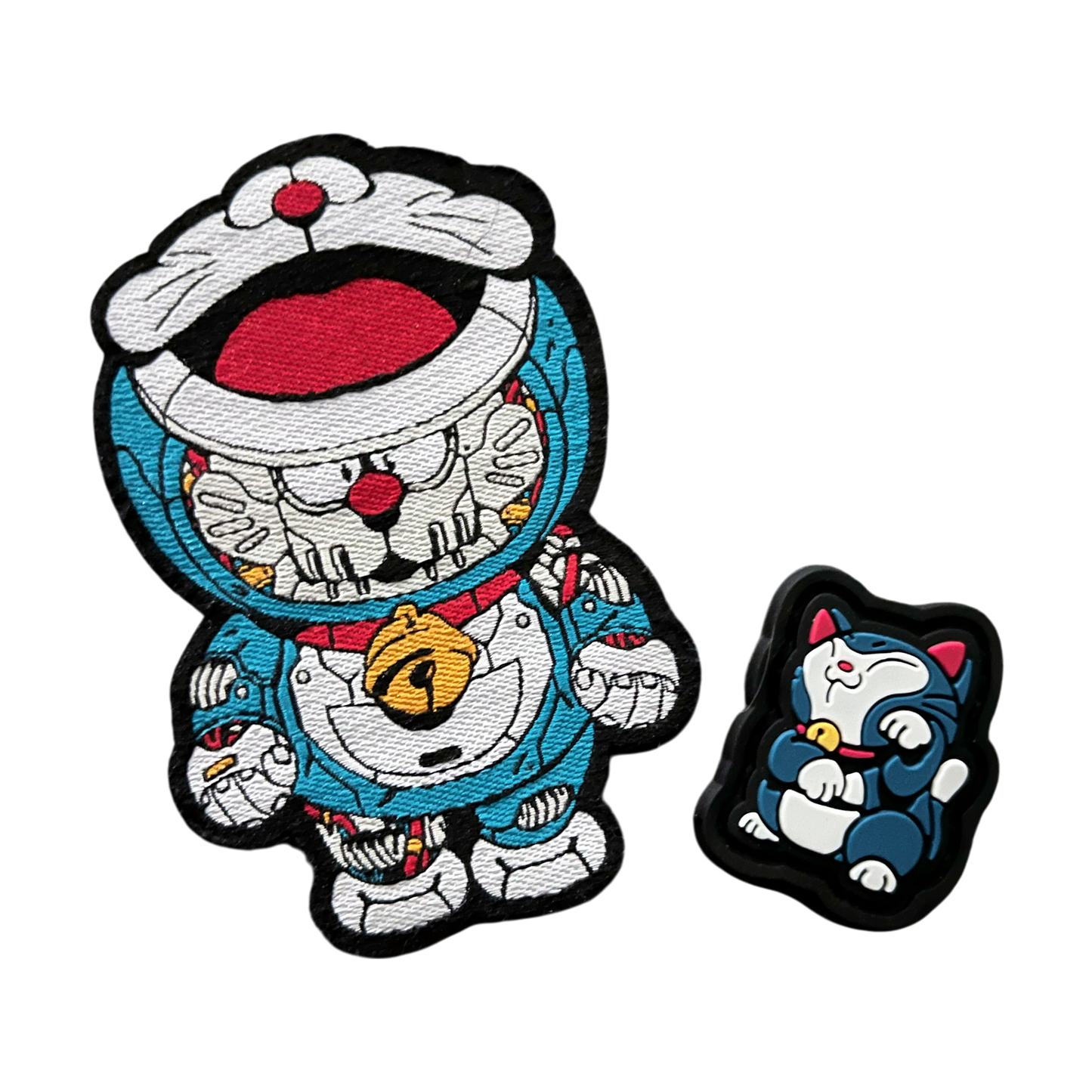 Doraemon Patch Set showing a blue mechanical cartoon cat embroidery patch and a 2D PVC morale patch of a blue cat in a lucky cat maneko pose.