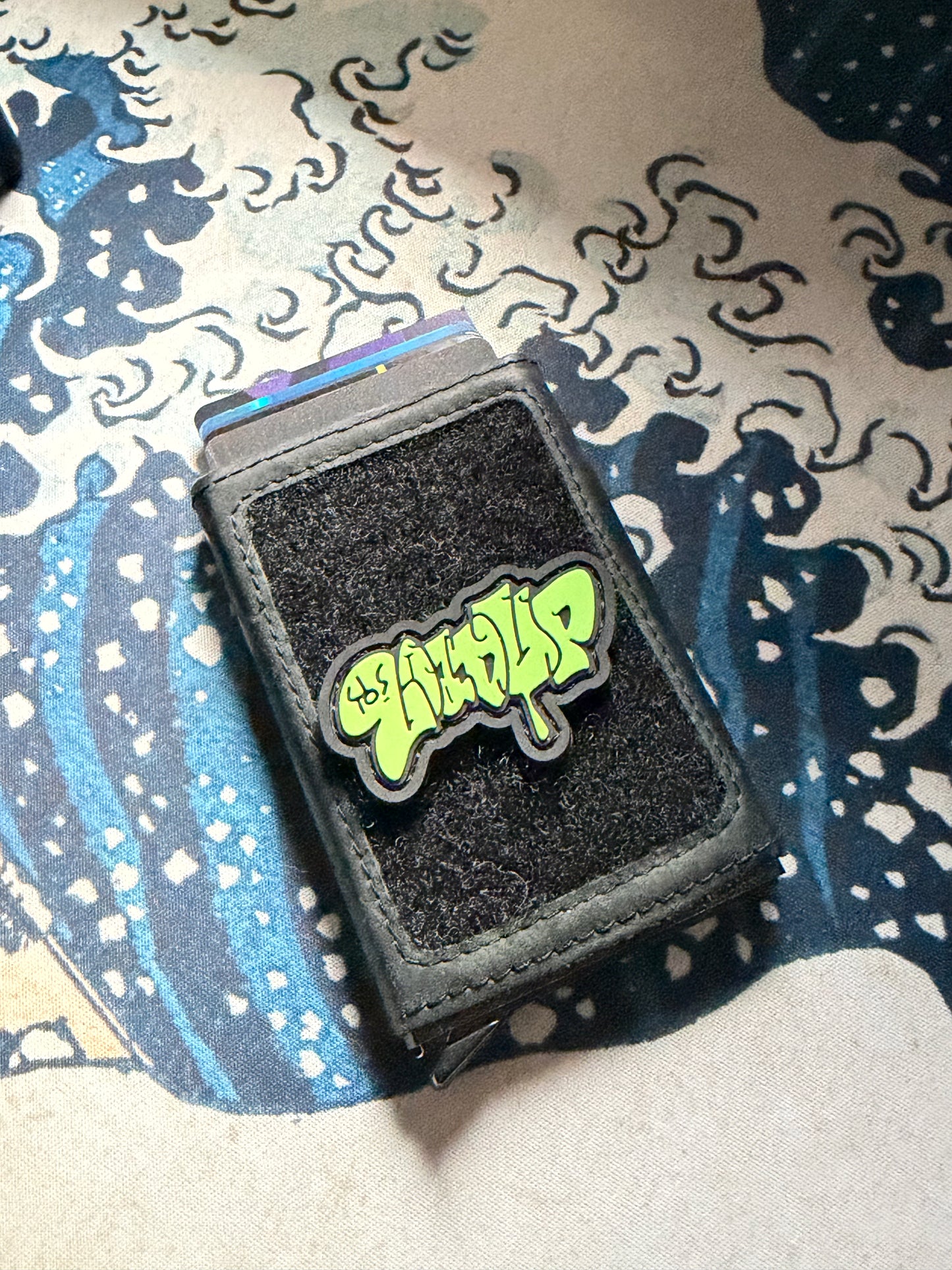 LOADUP Throw Up Lime RE PVC ranger eye morale patch of a graffiti graphic that says LOADUP on a velcro wallet with a Great Wave background.
