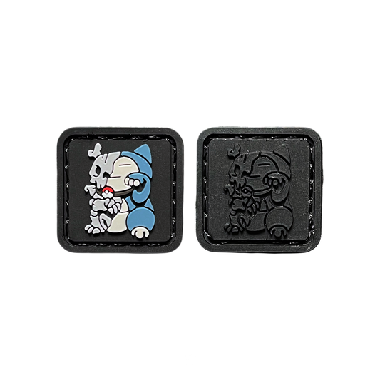 Myke Cruz x LOADUP Skull Neko RE Set PVC ranger eye morale patches of a green monster with bones sticking out sitting in a lucky cat maneki neko pose. The other patch is the same character but fully blacked out in color.