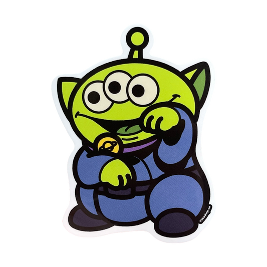 Neko 3 Sticker of a green alien with three eyes and a blue outfit standing in a lucky cat maneki-neko pose.