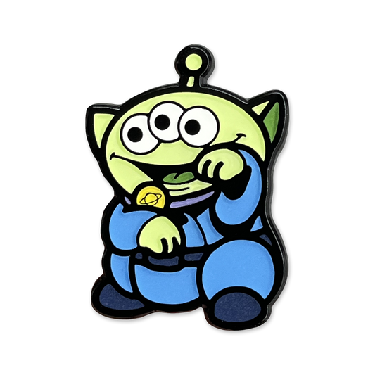Alien Neko Pin enamel pin showing a green cartoon alien with 3 eyes wearing a blue outfit in a lucky cat maneko pose.