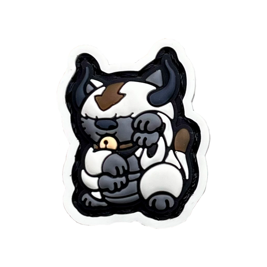 Appa Neko RE PVC ranger eye morale patch of a white bison with brown arrow on its forehead sitting in a lucky cat maneki-neko pose.