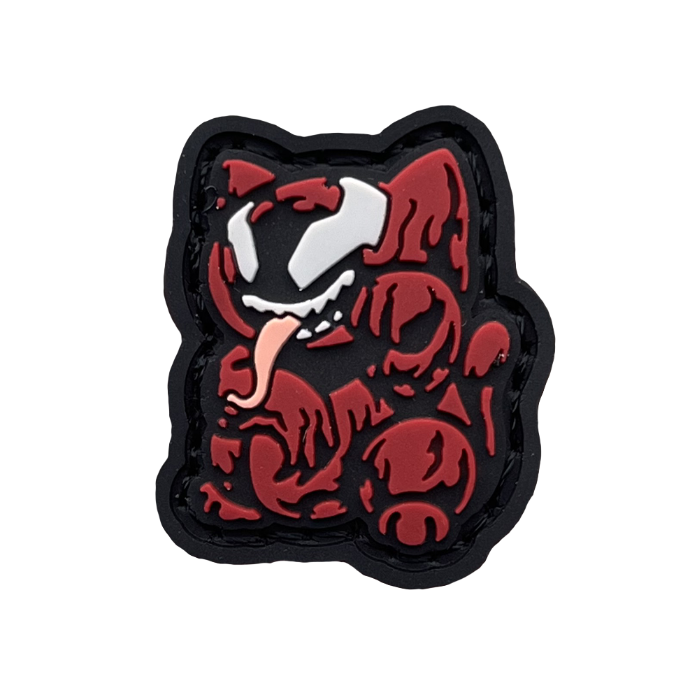 Carnage Neko RE PVC ranger eye morale patch of a red cartoon character with its tongue sticking out sitting in a lucky cat maneki-neko pose.