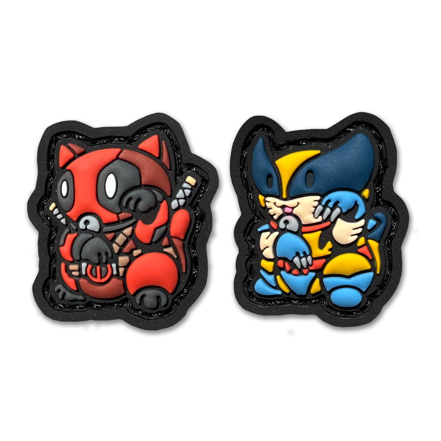 Deadpool & Wolverine Neko RE set PVC ranger eye morale patches of a character in a red suit and another character in a yellow and blue suit sitting in a lucky cat maneki-neko pose.