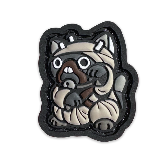 Desert Raider Neko RE PVC ranger eye morale patch of a cartoon character in a lucky cat maneki-neko pose.
