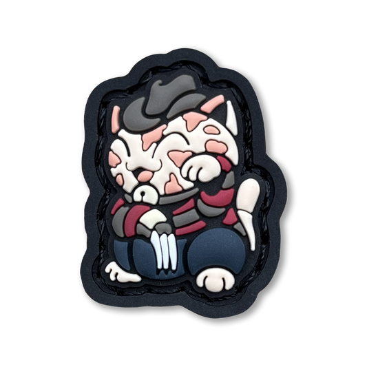 Dream Monster Neko RE PVC ranger eye morale patch of a cartoon character in a lucky cat maneki-neko pose.