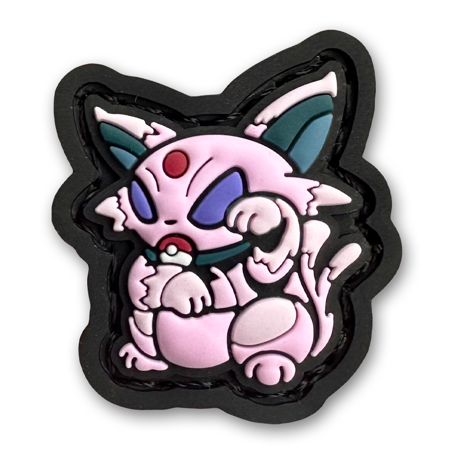 Espeon Neko RE PVC ranger eye morale patch of a pink monster character sitting in a lucky cat maneki-neko pose.