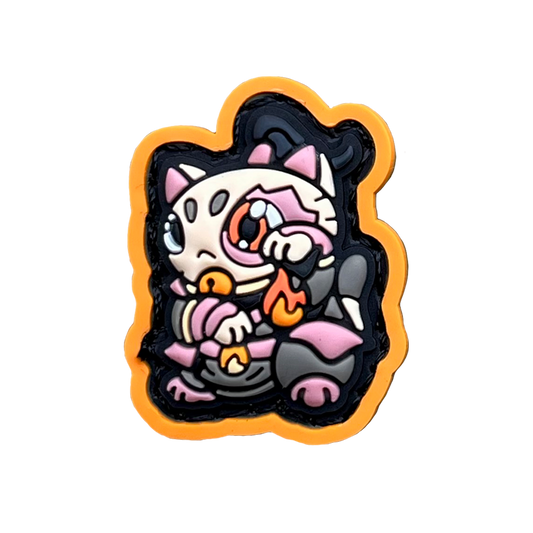 Fire Lord Neko RE PVC ranger eye morale patch of a cartoon character with an eye scar in red and orange clothes sitting in a lucky cat maneki-neko pose.