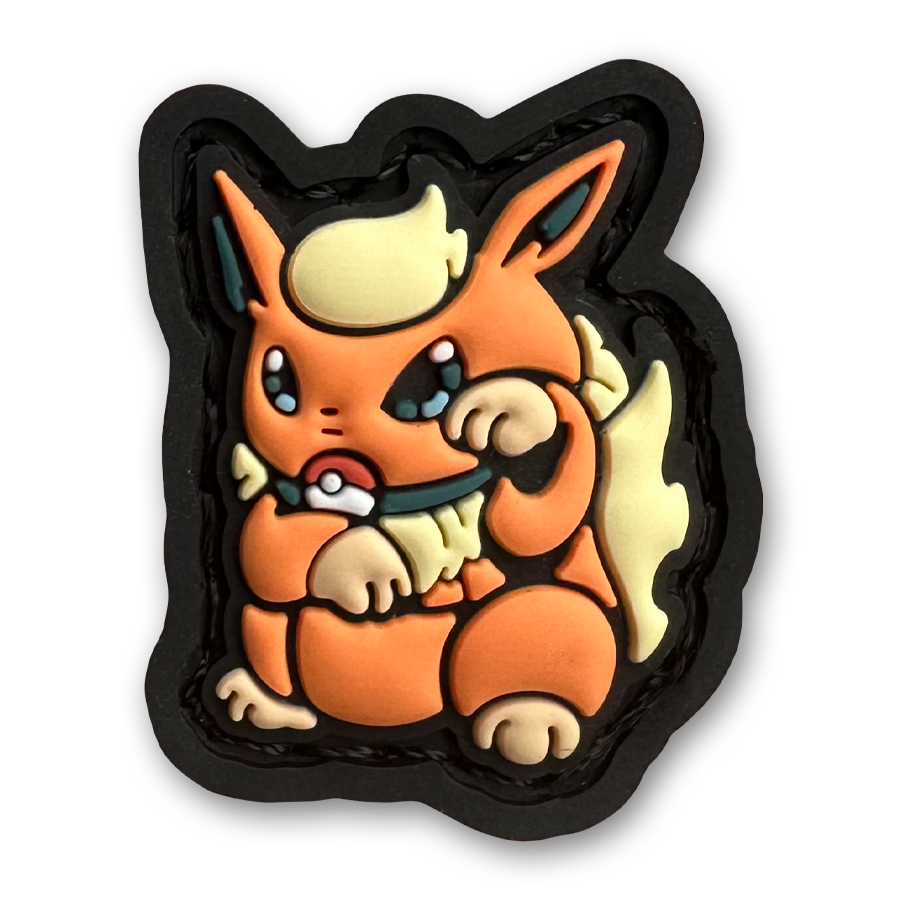 Flareon Neko RE PVC ranger eye morale patch of an orange monster character sitting in a lucky cat maneki-neko pose.