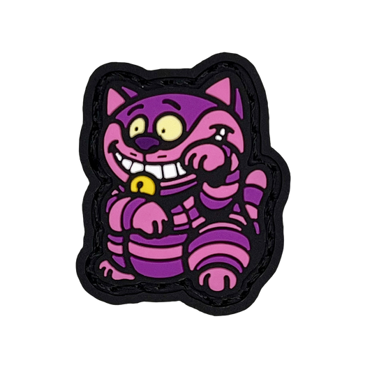 Grinning Cat Neko RE PVC ranger eye morale patch of a purple and pink cat sitting in a lucky cat maneki-neko pose.