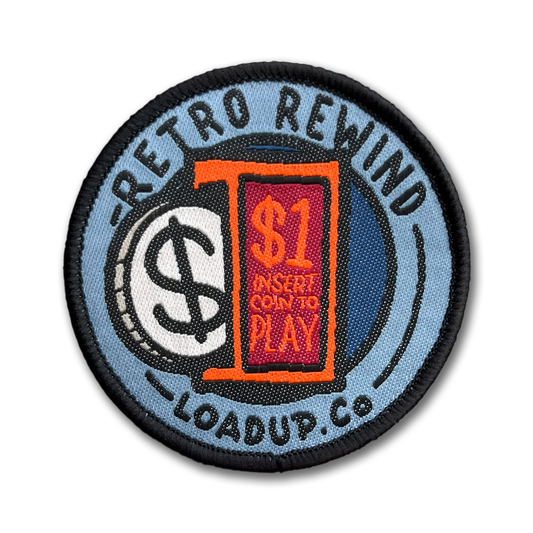 Insert Token Patch round woven nylon patch depicting an arcade insert coin to play slot, with a coin sticking in and the words 'RETRO REWIND LOADUP.CO' surrounding it in a circle