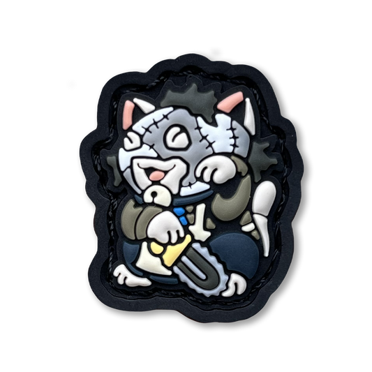 Leatherface Neko RE PVC ranger eye morale patch of a character in a mask holding a chainsaw sitting in a lucky cat maneki-neko pose.