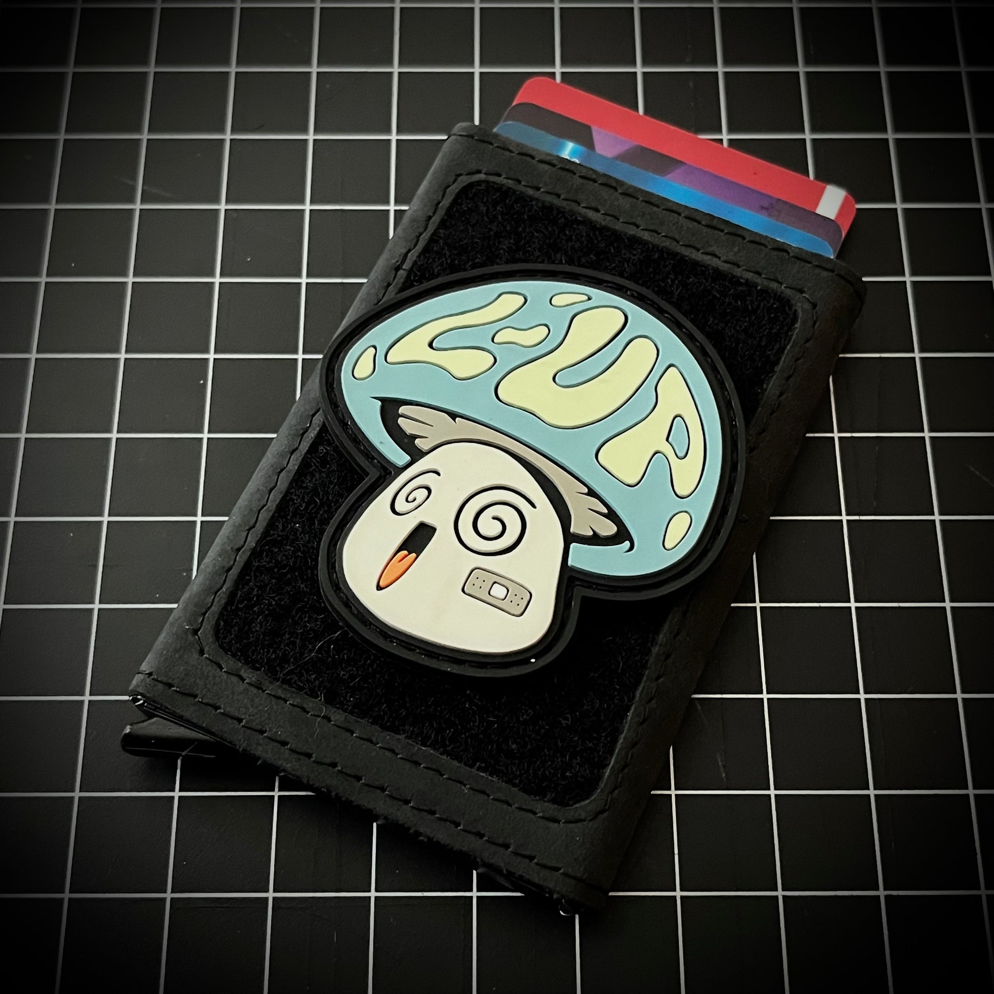 LoadUp Mushroom RE on a velcro wallet and grid background.