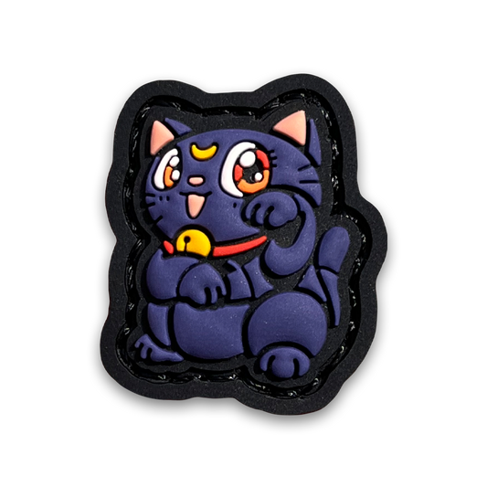 Luna Neko RE PVC ranger eye morale patch of a purple cat with a crescent moon mark on its forehead sitting in a lucky cat maneki-neko pose.