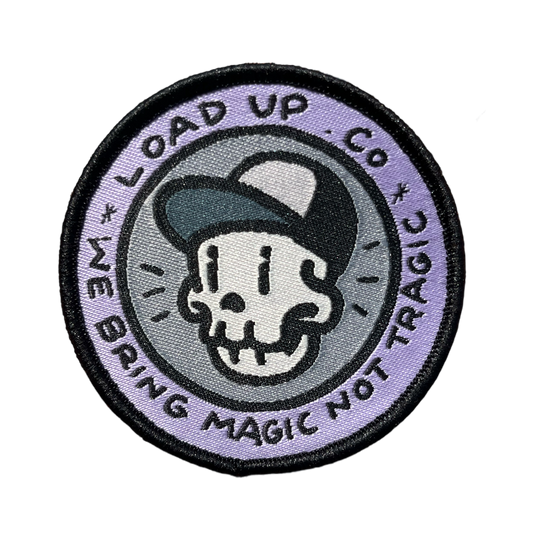 LOADUP.CO Magic Not Tragic Patch circle patch featuring a skull design with a cap and text that says LOADUP CO WE BRING MAGIC NOT TRAGIC.