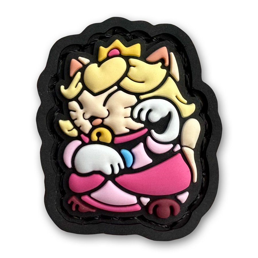 Peach Neko RE PVC ranger eye patch of a blonde girl cartoon character wearing a pink dress sitting in a lucky cat maneki-neko  pose.