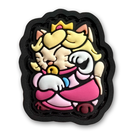 Princess Neko RE PVC ranger eye patch of a blonde girl cartoon character wearing a pink dress sitting in a lucky cat maneki-neko  pose.