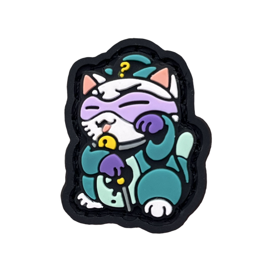 Puzzle Master Neko RE PVC ranger eye neko patch of a character in a purple mask and green outfit sitting in a lucky cat maneki-neko pose.