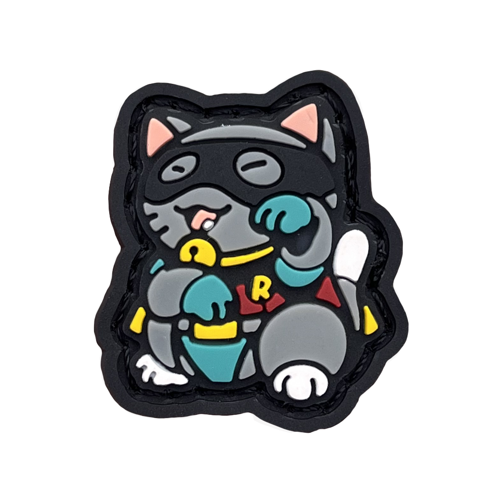 Robin Neko RE PVC ranger eye morale patch of a gray cat wearing a mask and sidekick outfit in a lucky cat maneki-neko pose.