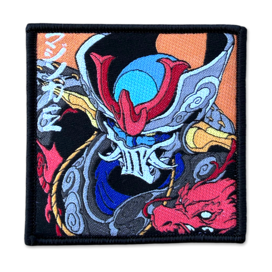 A square embroidered patch featuring a stylized Japanese samurai warrior helmet and armor design in black, blue, red, gray, orange, and white, with Japanese characters on the left side.