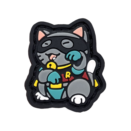 Sidekick Neko RE PVC ranger eye morale patch of a gray cat wearing a mask and sidekick outfit in a lucky cat maneki-neko pose.
