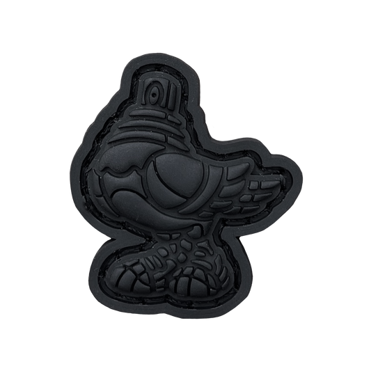 Spraygeon RE - Blackout PVC ranger eye morale patch of a fully black pigeo with spray paint can tip for a head and wearing tennis shoes.