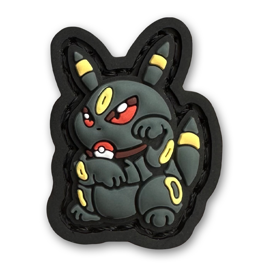 Umbreon Neko RE PVC ranger eye morale patch of a black and yellow monster character sitting in a lucky cat maneki-neko pose.