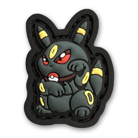 Umbreon Neko RE PVC ranger eye morale patch of a black and yellow monster character sitting in a lucky cat maneki-neko pose.