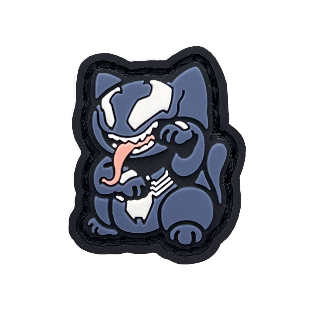 Venom Neko RE PVC ranger eye morale patch of a blue cartoon character with its tongue sticking out sitting in a lucky cat maneki-neko pose.