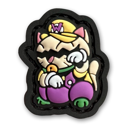 Wario Neko RE PVC ranger eye morale patch of a cartoon character with a mustache and yellow and purple clothes sitting in a lucky cat maneki-neko pose.