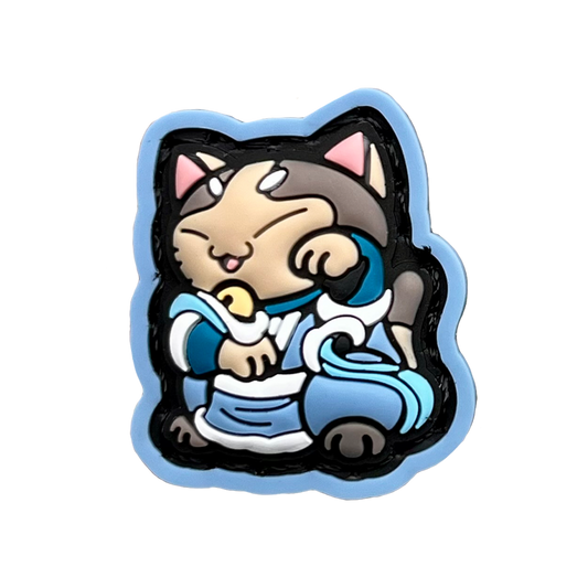 Water Bender Neko RE PVC ranger eye morale patch of a cartoon character girl cat with brown hair and blue clothes sitting in a lucky cat maneki-neko pose.