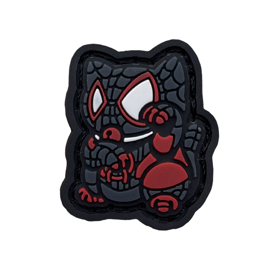 Webbed Hero Neko RE PVC ranger eye morale patch of a superhero character in black and red clothing sitting in a lucky cat maneki-neko pose.